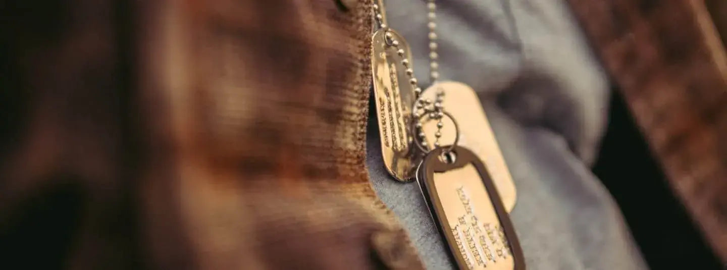 Closeup of a military person's dog tag necklaces.