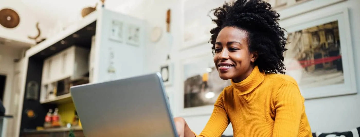 A woman in an office on her laptop.