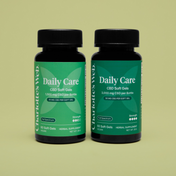 Product Image for Two bottles of Charlotte's Web Daily Care CBD Soft Gels on a green background