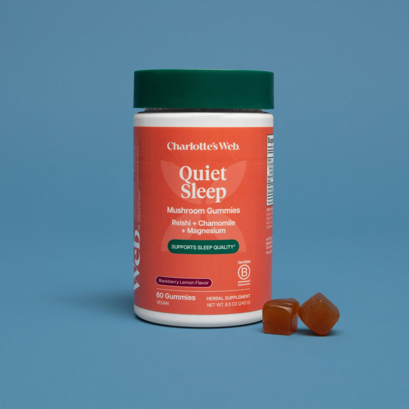 Charlotte's Web Quiet Sleep mushroom gummies container with two gummies on a blue background