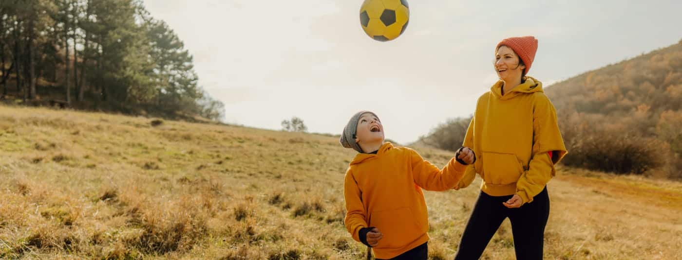 Mother and child enjoy outdoor activities together on a sunny day, showcasing wellness and balance. 