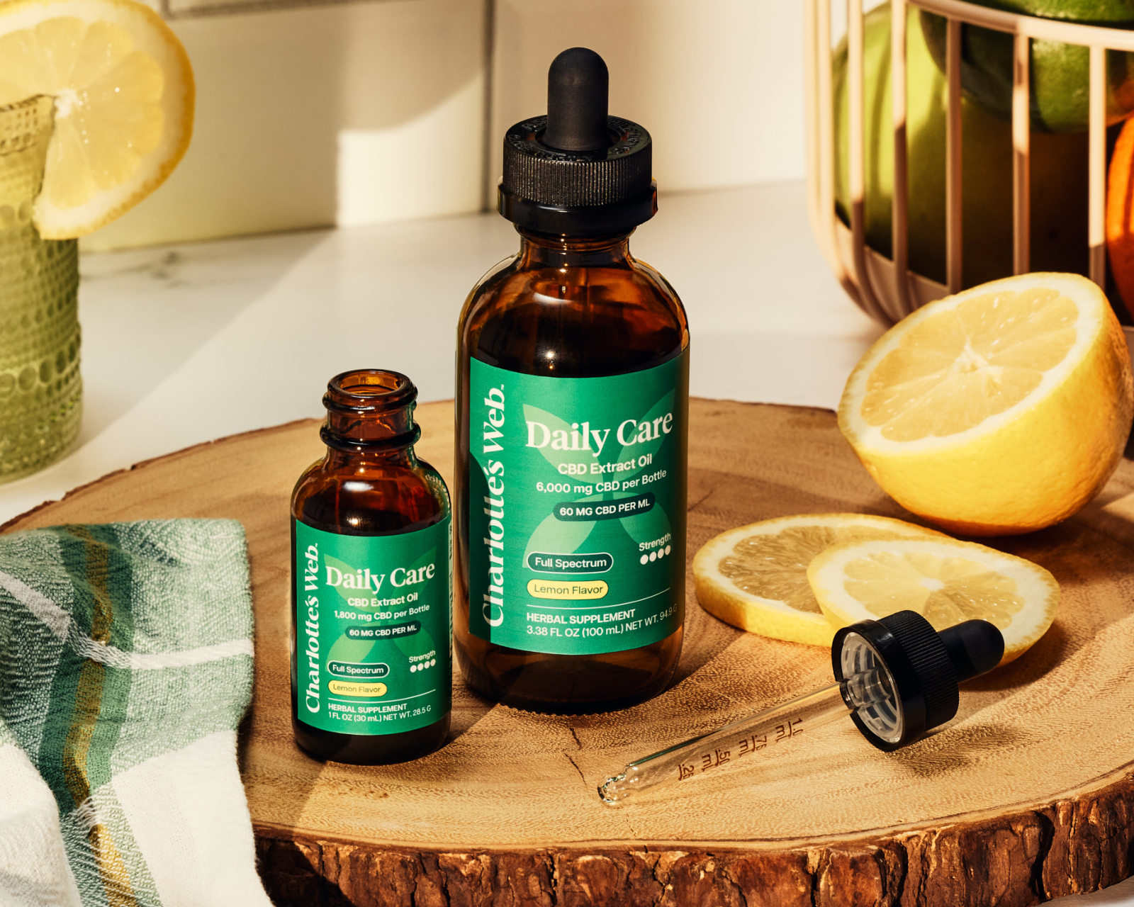 Daily Care Oils on wooden plate with citrus fruit