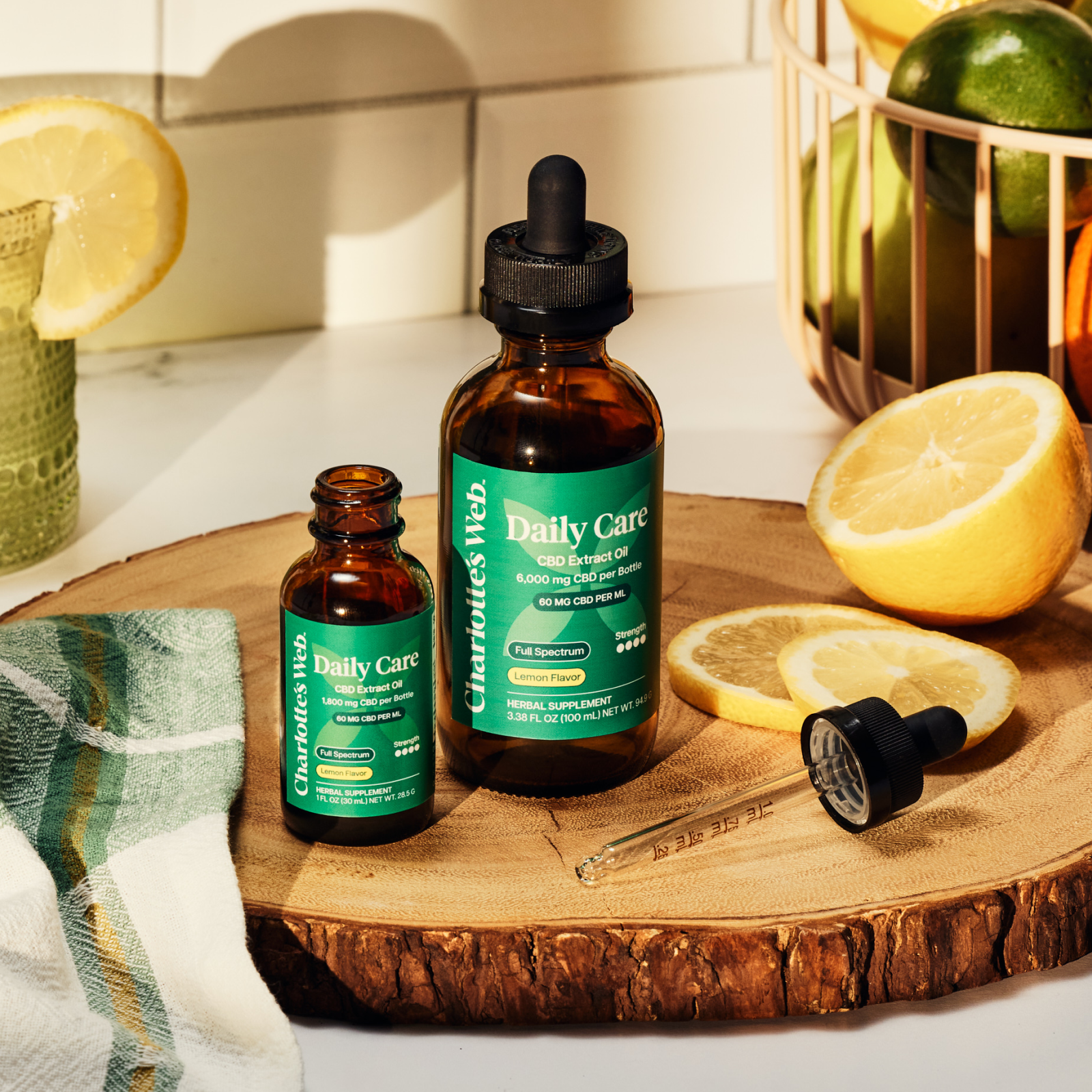 Daily Care Oils on wooden plate with citrus fruit