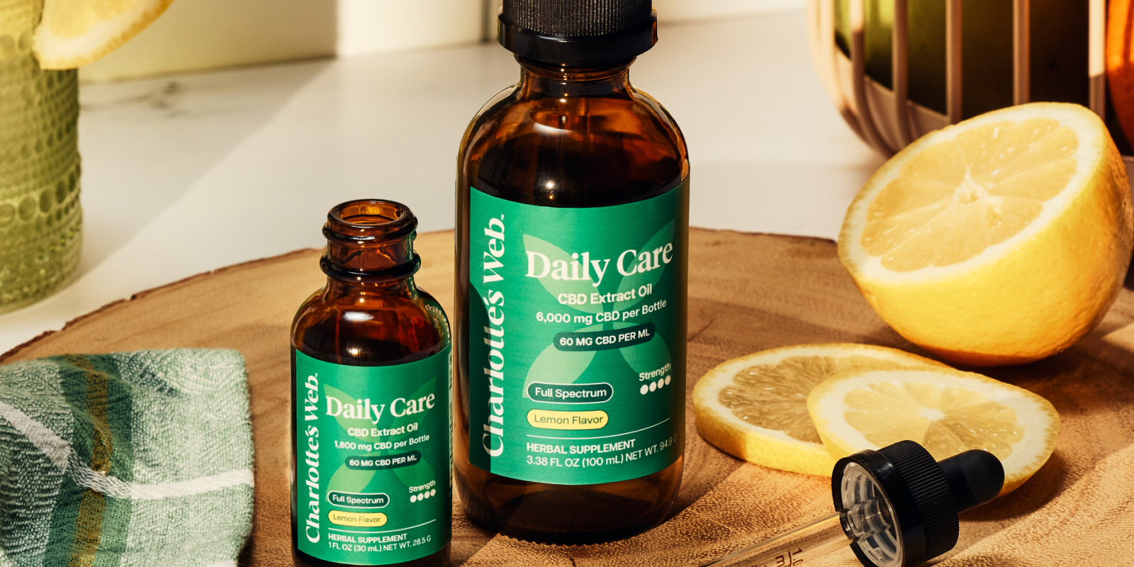 Daily Care Oils on wooden plate with citrus fruit