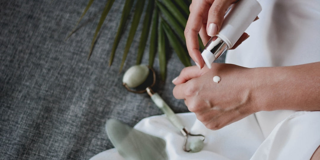 Applying moisturizer with jade roller and palm leaf