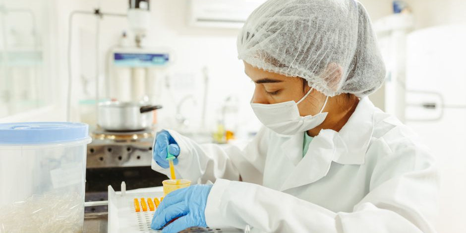 Scientist filling capsules in lab