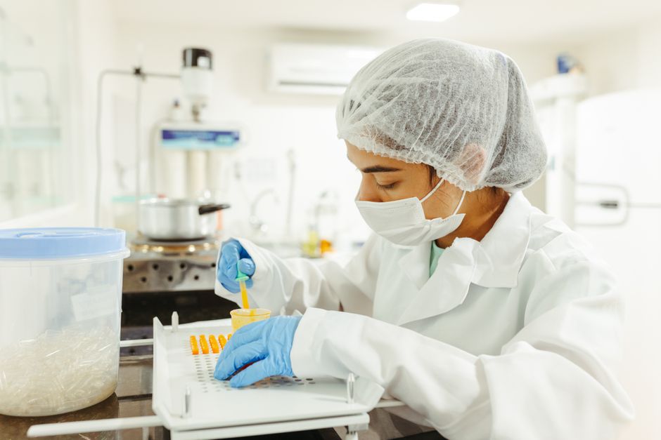 Scientist filling capsules in lab