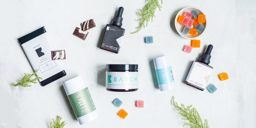 Various CBD items and gummies on white background