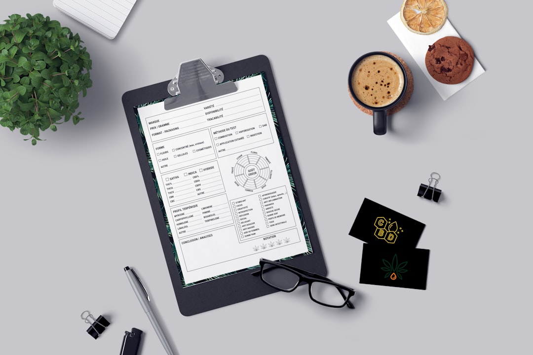 Clipboard, coffee, glasses, cards and cookie on desk