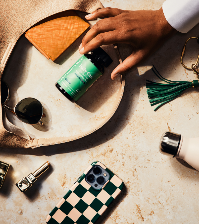 Person interacting with various items on a checkered tablecloth