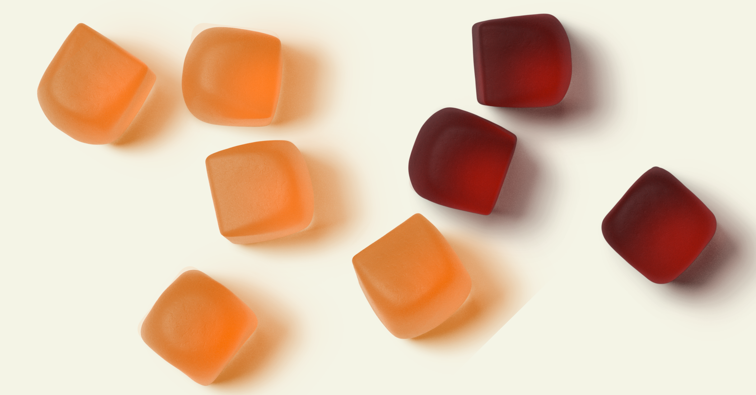 Orange and red gummy cubes on a white background