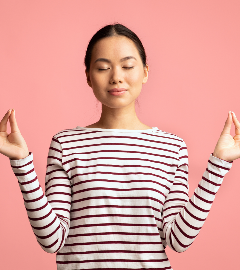Woman wearing a striped shirt against a pink background