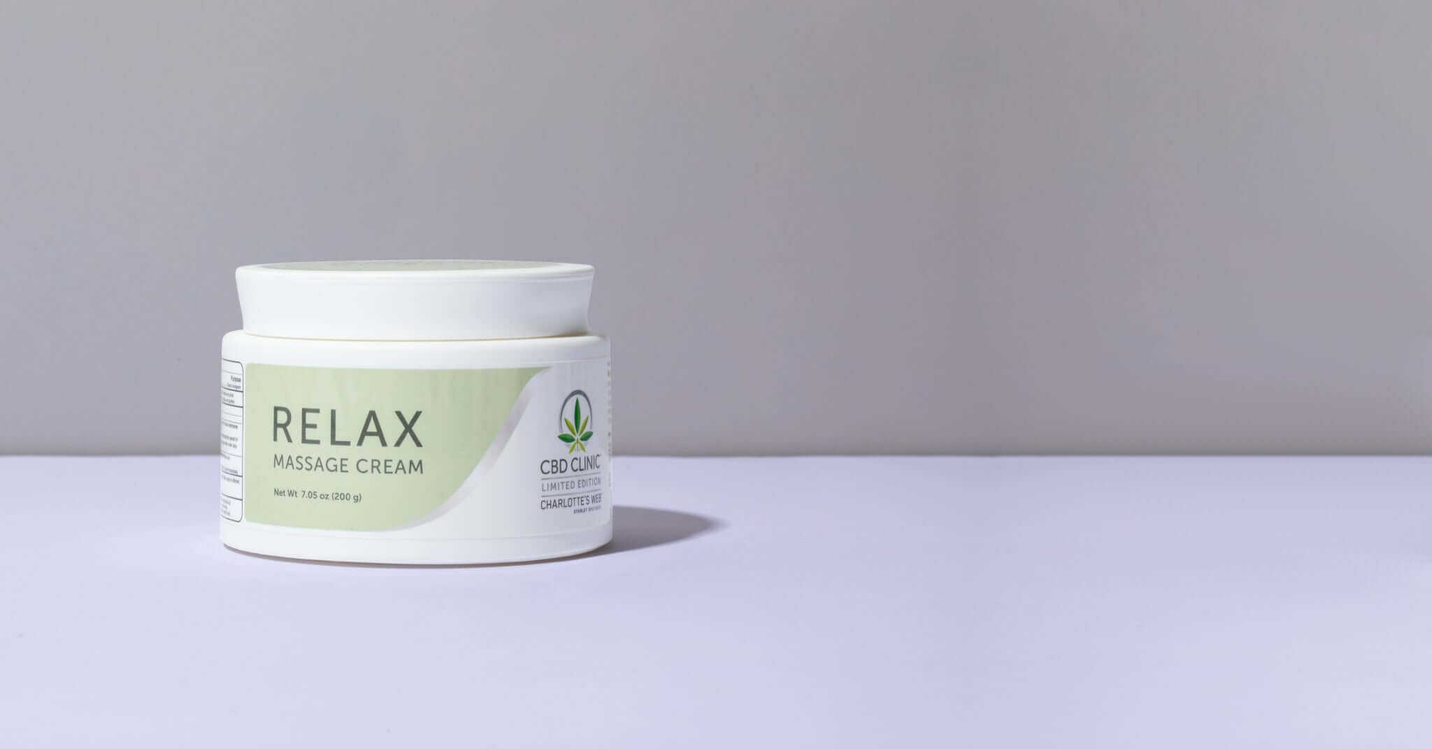 Jar of Relax massage cream on a light gray background