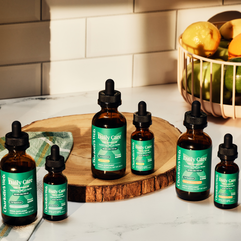 Charlotte's Web Daily Care CBD Oils on wood plate
