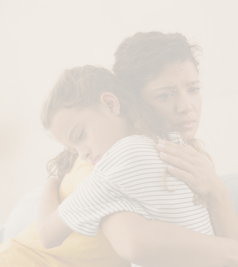 Two people embracing each other with a soft, blurred background