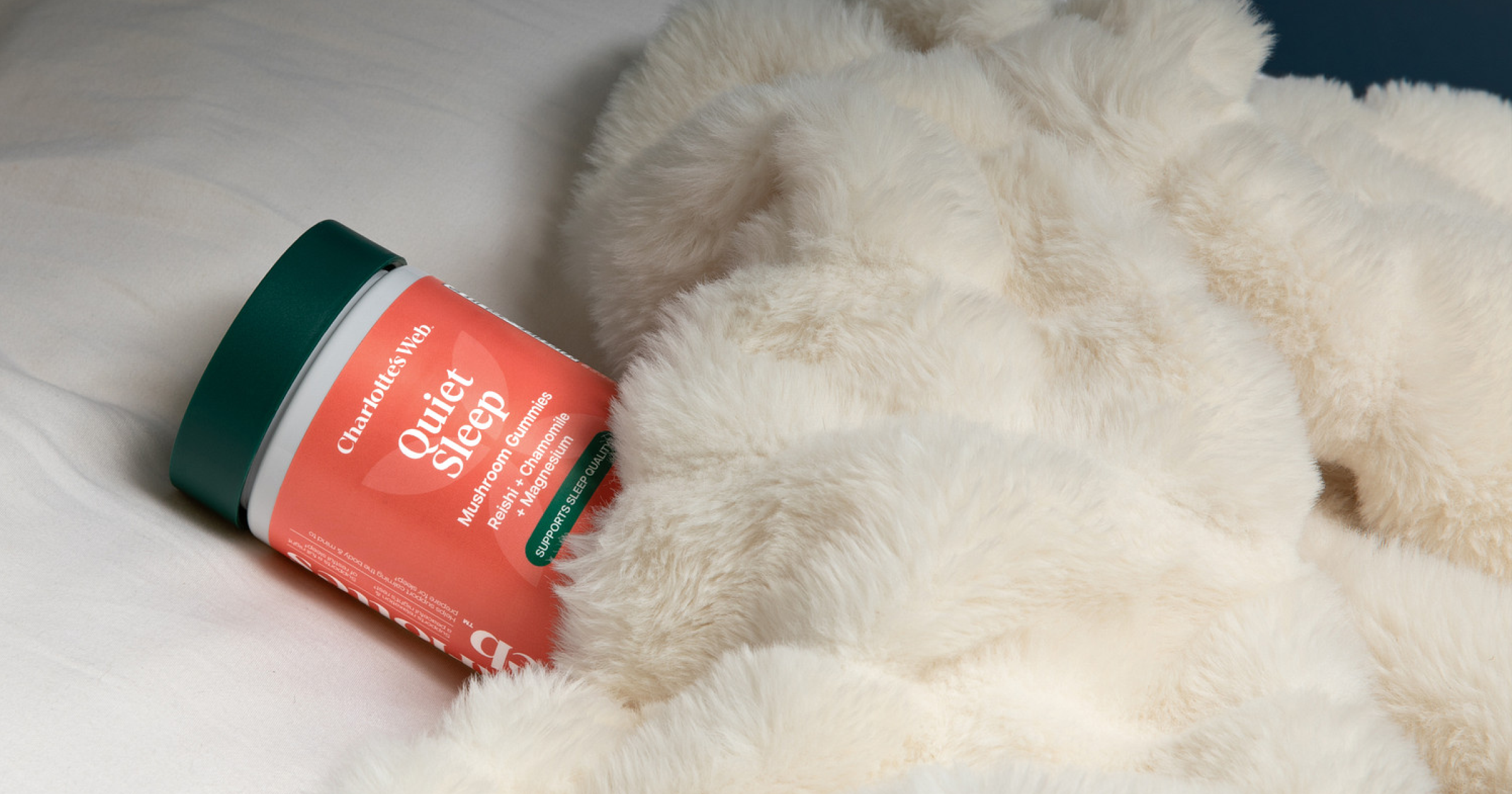 Jar of 'Quiet Sleep' supplement on a fluffy white blanket