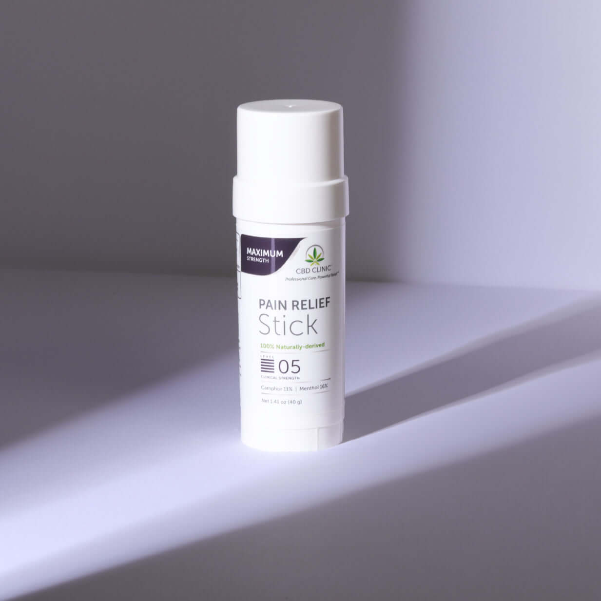 Pain relief stick on a gray background